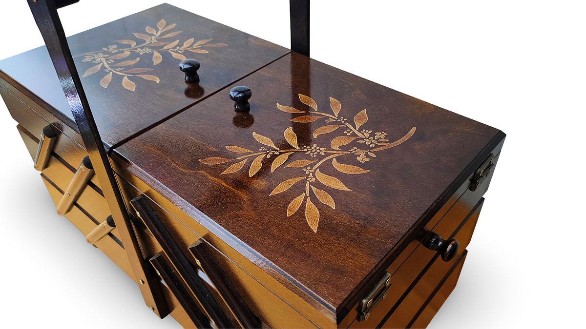Close-up of engraved leaf branch detail on dark walnut extra large wooden sewing box lid 