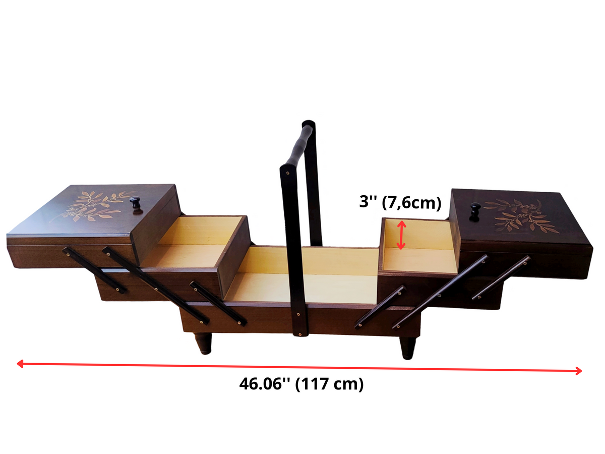 An extra large wooden sewing box with dark walnut color and leaf branch patterns on the lid, equipped with a handle and accordion-style drawers. Fold-out tiered drawers. Fully expanded with dimension